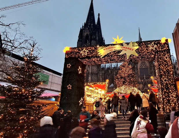 Entrance to a Christmas market with festive lights.