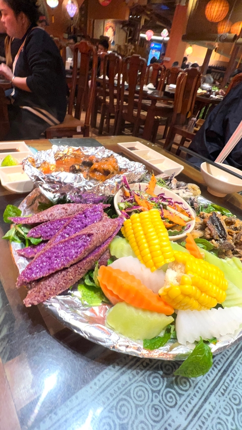 Colorful traditional meal with various Vietnamese dishes.