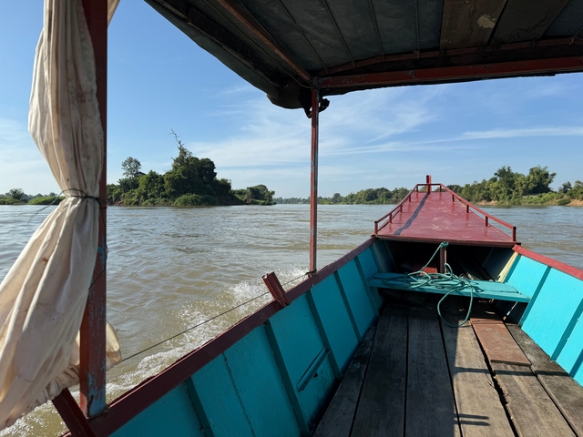       Boat ride on a wide river with scenic views.
  