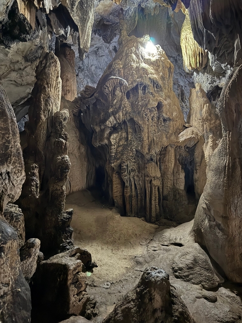       Cave interior with stalactites visible.
  