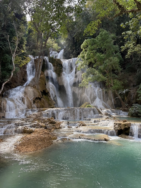 Beautiful waterfall cascading down several tiers surrounded by greenery.