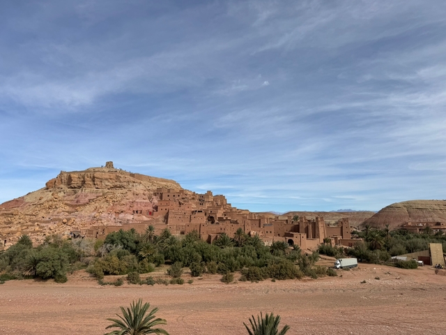       Panoramic view of the Ait Benhaddou kasbah with a blue sky above.
  