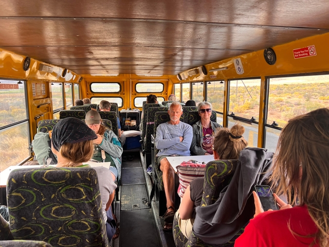 People sitting inside a safari bus during a tour.