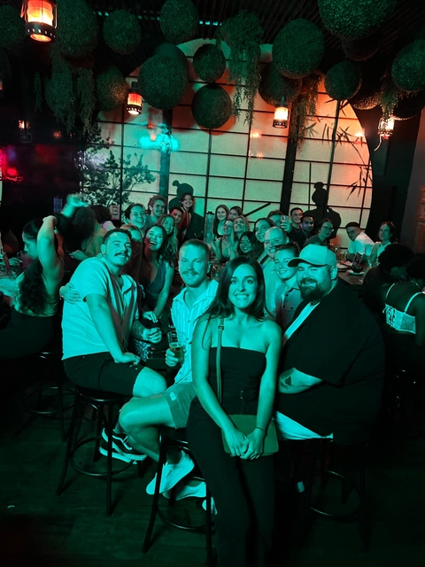 Indoor group gathering with people enjoying a social event.