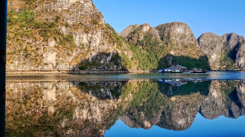       Scenic view of karst limestone islands reflecting on the calm water.
  