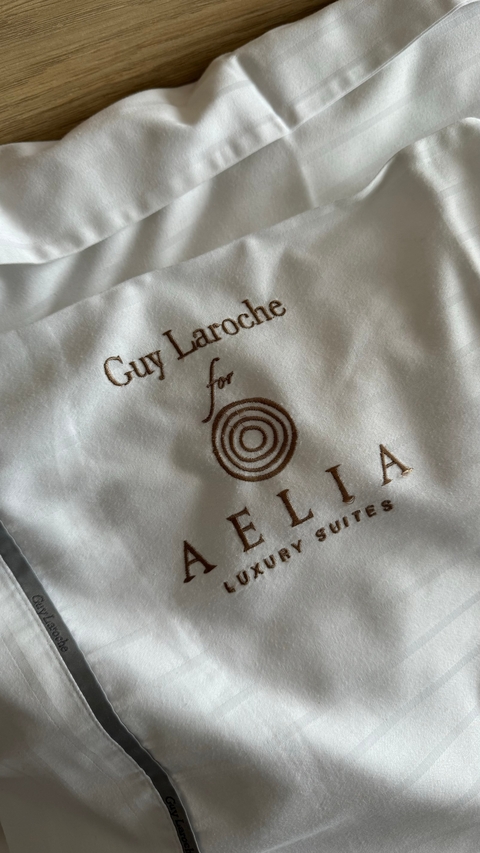       Close-up of text embroidered on fabric.
  