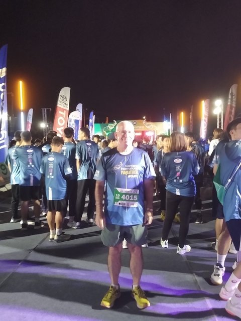       Event with people in matching shirts, likely a race or marathon at night.
  