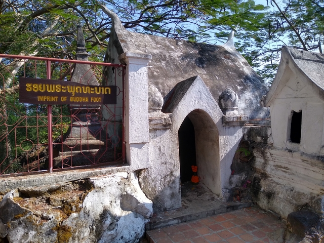 Small historical structure with sign 'Imprint of Buddha Foot'.