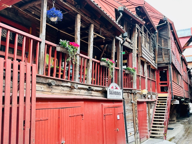 Wooden buildings with potted flowers, showcasing traditional architecture.