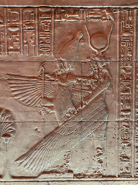 Ancient Egyptian wall carvings with intricate details.