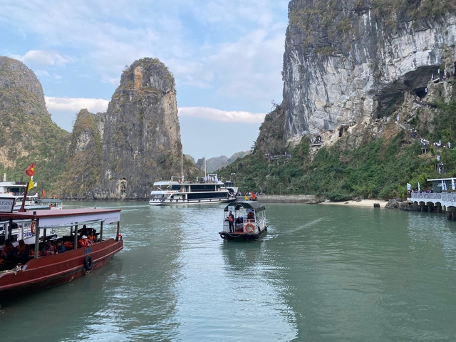 Boats on the water with limestone karsts in the background.