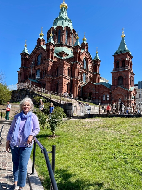People in front of a red brick cathedral.