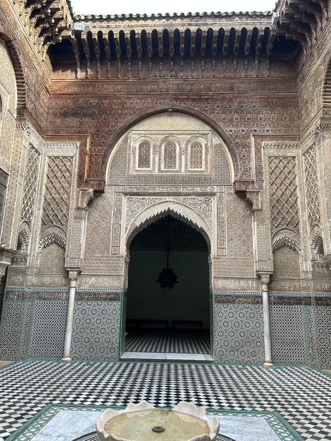       Ornate entrance of a Moroccan building with detailed designs.
  
