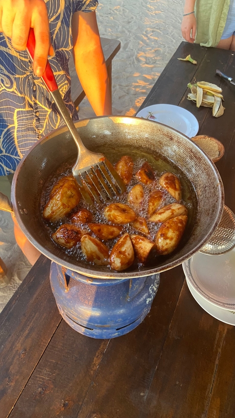       Close-up of food frying in a pan with oil.
  