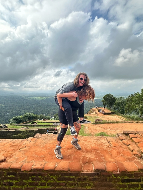 Two people playing in a scenic elevated landscape.
