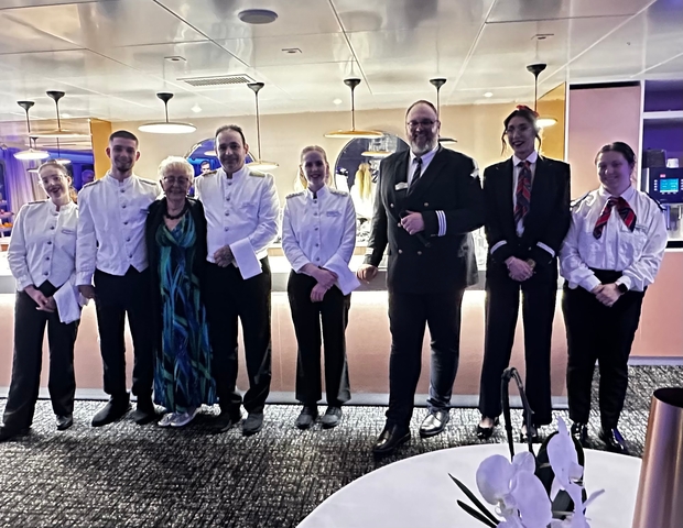 Group of staff members posing for a photo in uniform.