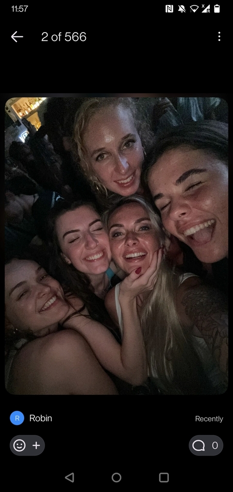       Group of people smiling closely together at night.
  