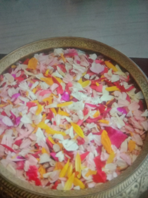 Colorful petals in a decorative bowl.