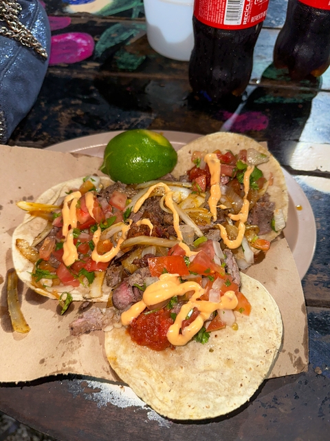 Close-up of tacos with toppings and lime.