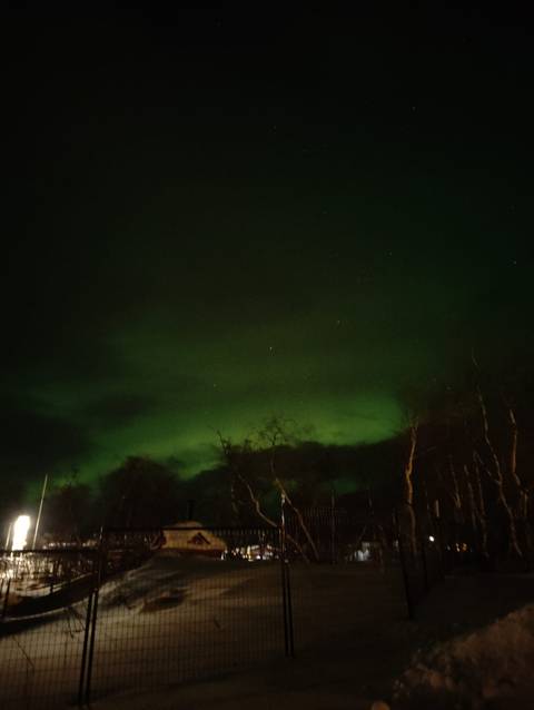 Northern Lights faintly visible in the night sky.