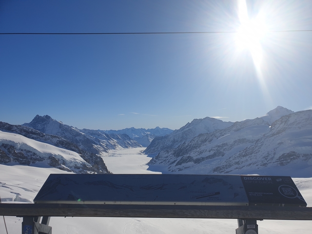       Snow-covered mountain landscape under a clear blue sky.
  