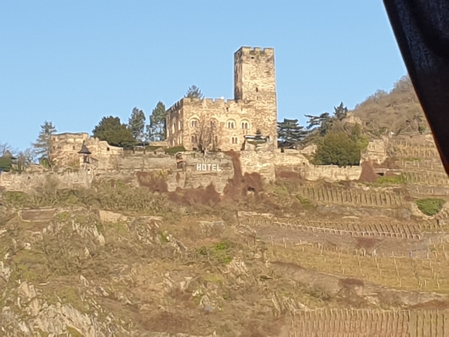       Distant view of a castle or hotel on a hillside.
  