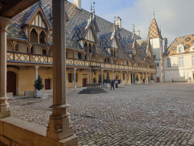       Interior courtyard with patterned building walls.
  