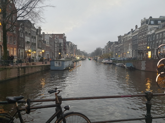       Canal in a city with residential buildings and boats.
  