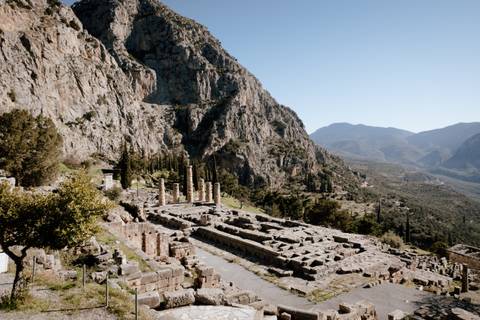       Archeological site of Delphi with mountainous backdrop.
  