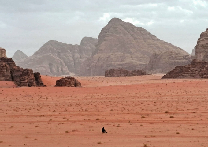Vast desert landscape with mountain backdrops.