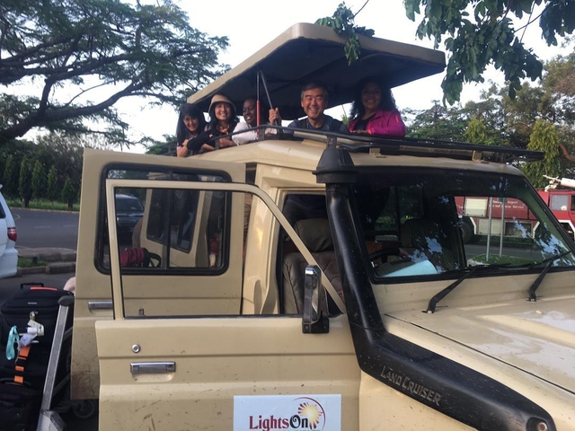 Group of people in a safari vehicle.