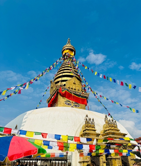 A stupa with colorful prayer flags.