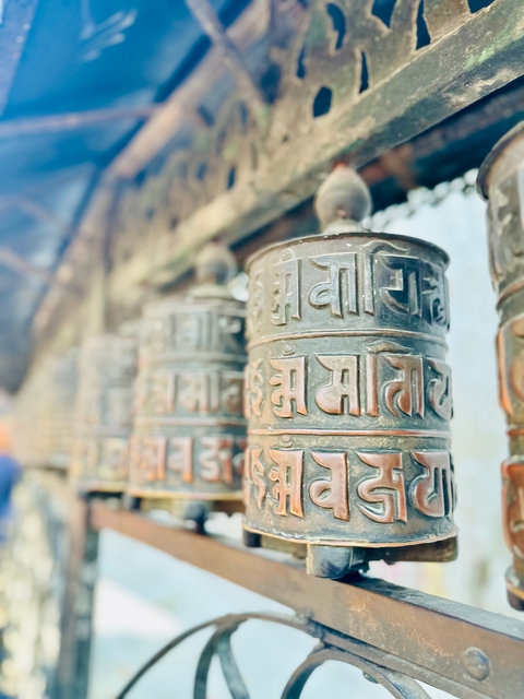       Prayer wheels with carved inscriptions.
  