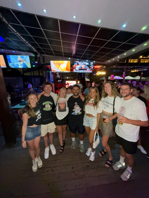 Group of friends posing in a bar.