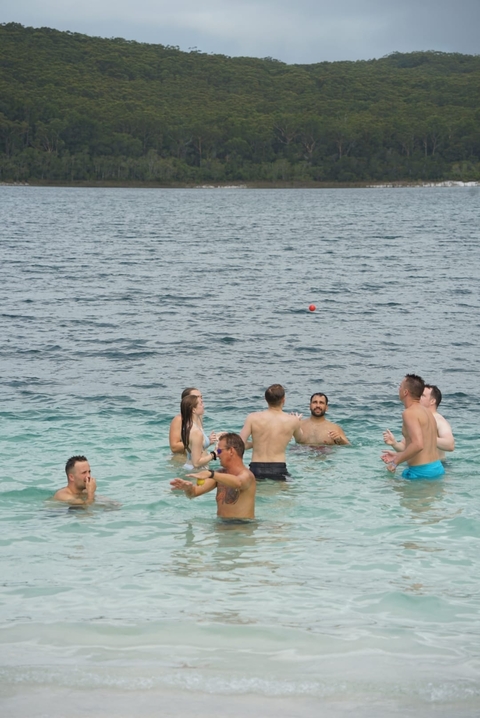       People enjoying the ocean, playing in the water.
  
