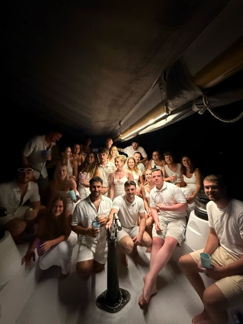 Group of people on a boat at night.