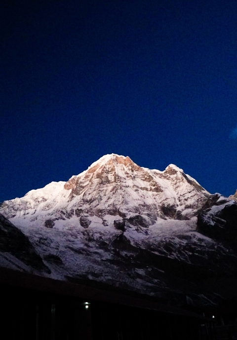       Snow-covered mountain with blue sky.
  