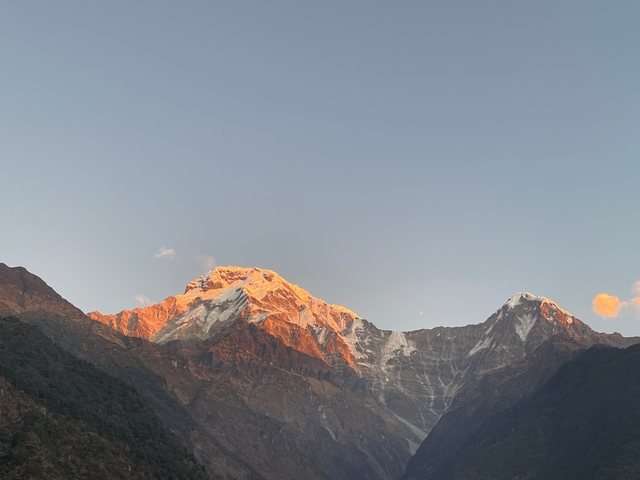       Mountains during sunset with orange glow.
  