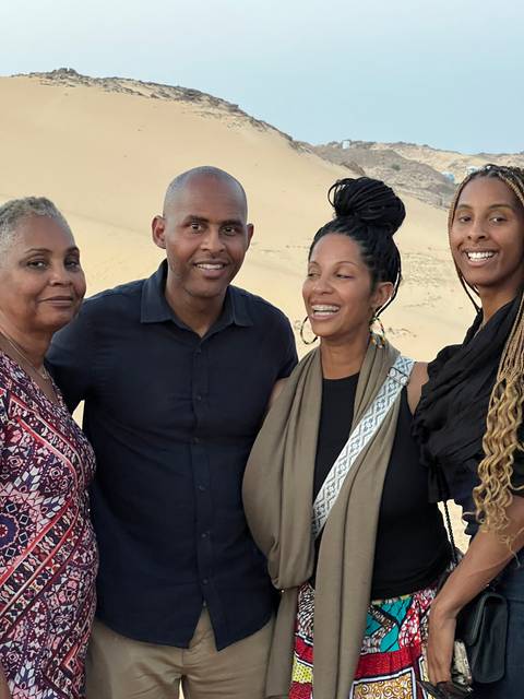       Group posing in the desert.
  