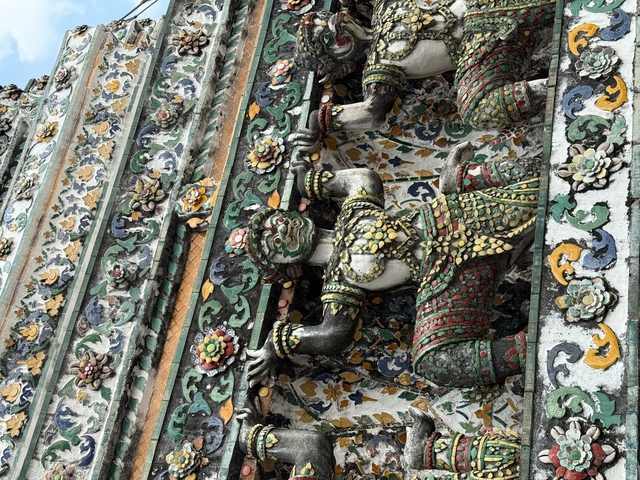 Decorative wall with statues and colorful patterns.
