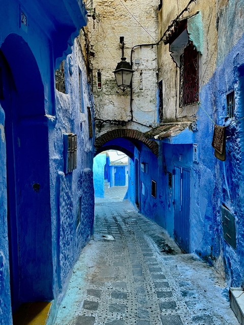       A narrow, winding street painted in bright blue.
  