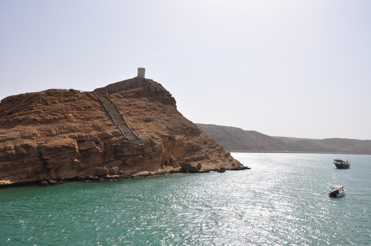 Coastal cliffs with a historic tower overlooking the sea.