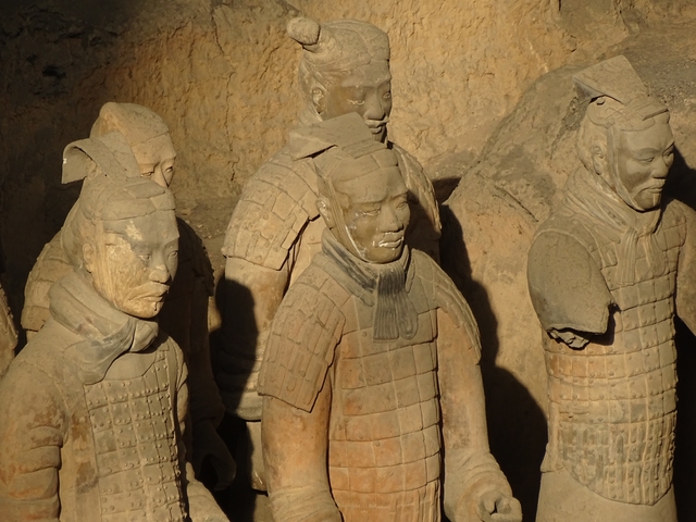       Terracotta warriors in an excavation site.
  