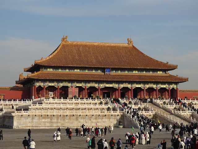 A large traditional Chinese palace with a crowd.