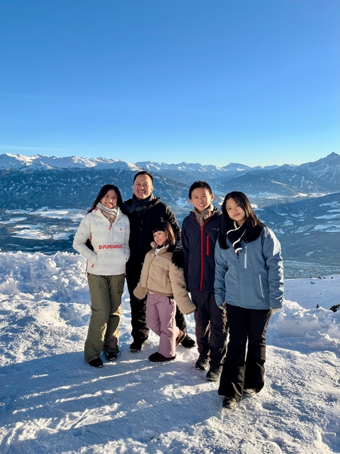 Family group photo with a snowy mountain background.