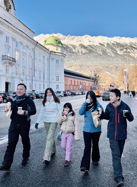Family enjoying a walk on a snowy street.