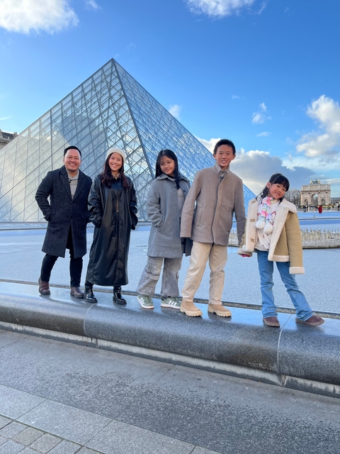 Family in front of the Louvre Pyramid.