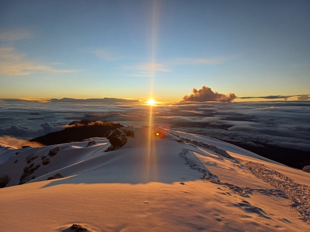 Breathtaking sunrise over a snow-covered mountain peak.