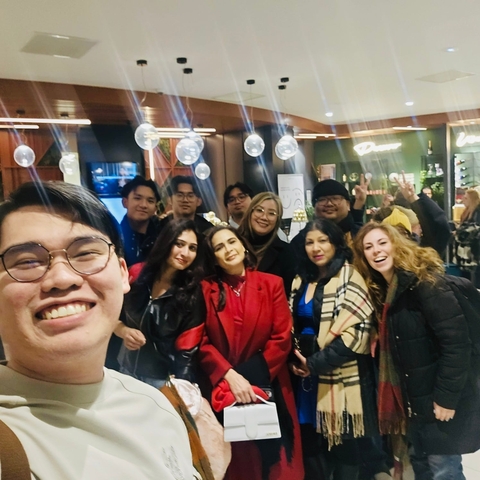 Group of people inside a store with balloons in the background.
