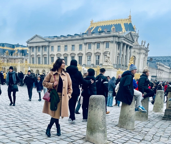 People standing in front of a historic palace entrance.